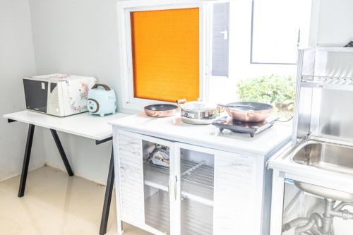 a kitchen with a counter with three bowls on it at Blue Carina Hotel Phuket in Phuket Town