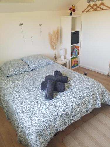 a teddy bear sitting on top of a bed at Gîte le Charmot, au pied des montagnes classé 3* in Roderen