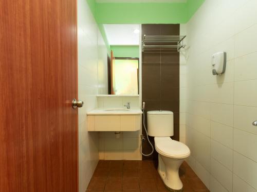 ein Bad mit einem WC und einem Waschbecken in der Unterkunft Royal Hotel in Keningau