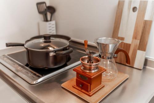 a kitchen counter with a pot and a blender on a stove at 川HOUSE旭 in Osaka
