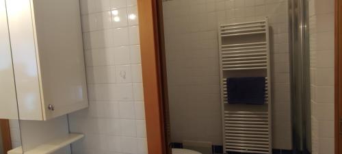 a bathroom with a toilet and a glass shower at In Centro 2 in Borgosesia