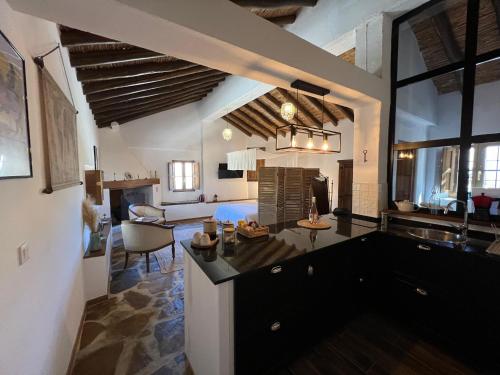a room with a kitchen and a living room at Finca Altozano - Private pool - Unique client in Valle de Abdalagís