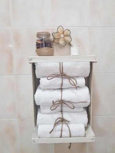 a stack of towels on a shelf in a bathroom at La Tana degli Orsetti in Barrea