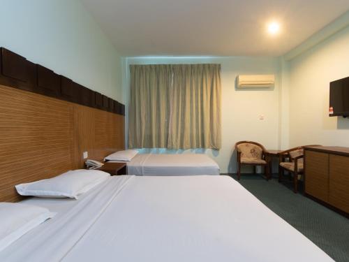 Postel nebo postele na pokoji v ubytování Royal Hotel