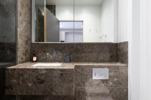 a bathroom with a sink and a mirror at Central Reading Designer Studio in Reading