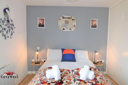 a bedroom with a bed with two tables and a mirror at Elegant Central Self Contained Flat by CozyNest. in Reading