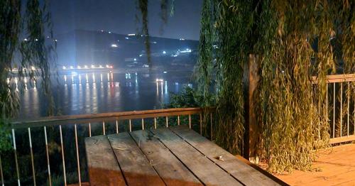 a wooden bench sitting in front of a fence at פינת ביאן נוף לאגם in Majdal Shams
