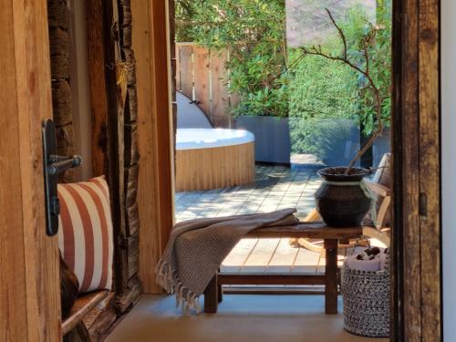 a sliding glass door to a patio with a tub at Weinstöckl Hochgrail pures sein in Sankt Stefan ob Stainz