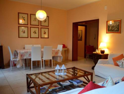 een woonkamer met een tafel en witte stoelen bij Villa Marina in Venetië-Lido