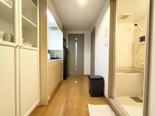 Hanabatachō的住宿－エスポアール新町Ⅵ(101)，走廊上的厨房配有冰箱和柜台