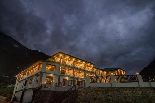 a large building with lights on it at night at Amritara The Avadh in Badrīnāth