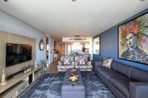 ケープタウンにあるHarbour's Edge Walk to V & A Waterfront and CTICCのソファとテレビのあるリビングルーム