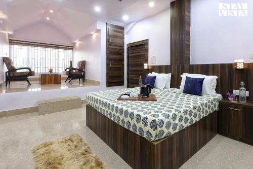 a bedroom with a large bed in a room at StayVista's Sunara Trails - Pet-Friendly, Mountainside Retreat with Balcony & Indoor-Outdoor Games - Near Panna National Park in Panna