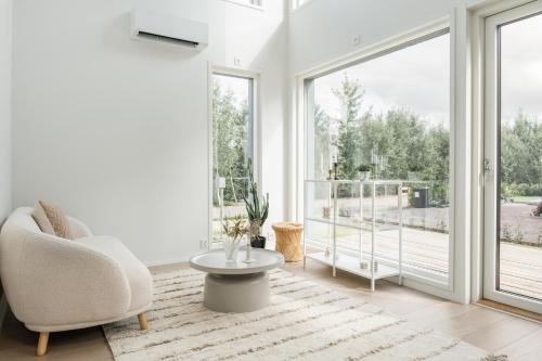 a living room with a chair and a table at Lovely Scandinavian Duplex for 6 and babybed in Vantaa Hiekkaharju Tikkurila in Vantaa