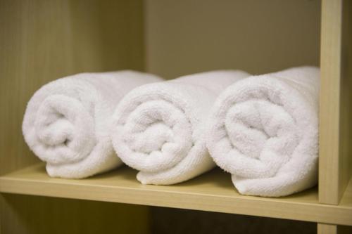 a group of towels sitting on a shelf at Hostel Seven in Prague