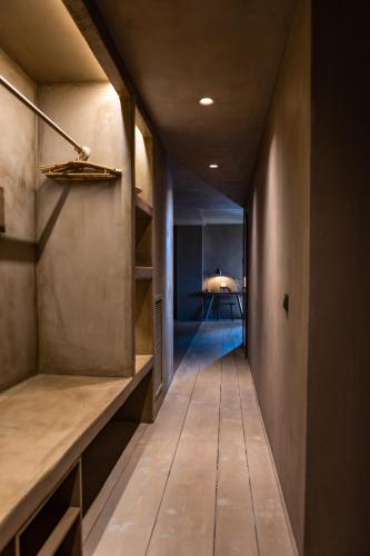 a long hallway with a room with a table in it at Life Gallery Hotel & Spa in Korçë
