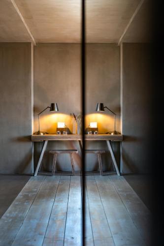 two tables in a room with two lamps on them at Life Gallery Hotel & Spa in Korçë