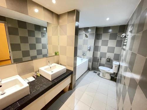 a bathroom with a sink and a toilet at Swing & Pillows - Sungei Wang Hotel Bukit Bintang in Kuala Lumpur