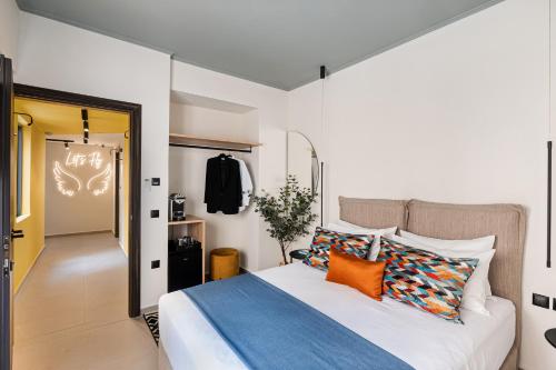a bedroom with a large bed with orange pillows at Airio Athens Suites in Athens