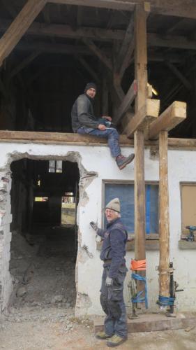 two men sitting on top of a building at Ferienhaus & -wohnung Flatscher in Waidring