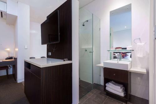 a bathroom with a sink and a mirror at Club Wyndham Perth, Trademark Collection by Wyndham in Perth