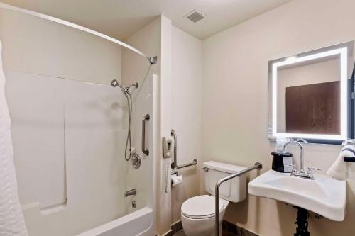 a bathroom with a toilet and a sink and a shower at SureStay Hotel by Best Western Twin Falls in Twin Falls