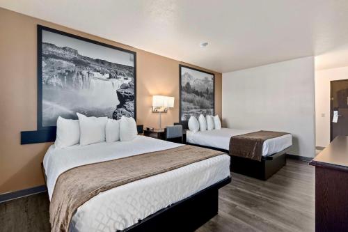 a hotel room with two beds and a tv at SureStay Hotel by Best Western Twin Falls in Twin Falls