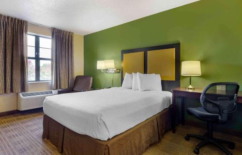 a hotel room with a bed and a desk and a chair at Extended Stay America Suites - Lynchburg - University Blvd in Lynchburg