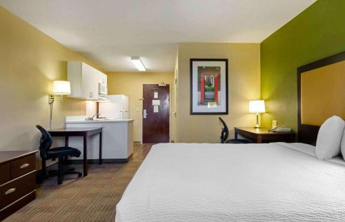 a hotel room with a large bed and a desk at Extended Stay America Suites - Lynchburg - University Blvd in Lynchburg