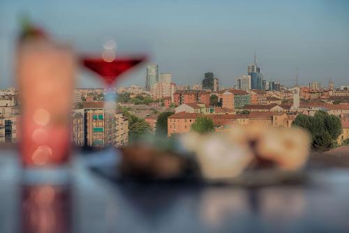 a view of a city skyline with a wine glass at Radisson Blu Hotel Milan in Milan