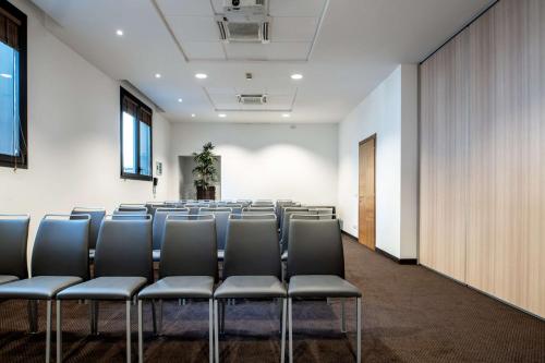 a row of chairs in a large room at Radisson Blu Hotel Milan in Milan