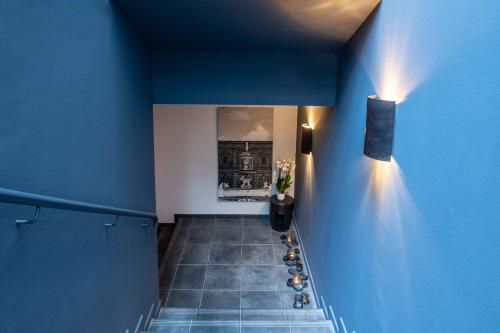 a hallway with blue walls and a blue wall at Radisson Blu Hotel Milan in Milan