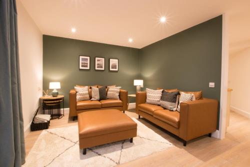 a living room with two chairs and a couch at Melfort Pier & Harbour Resort in Kilmelfort