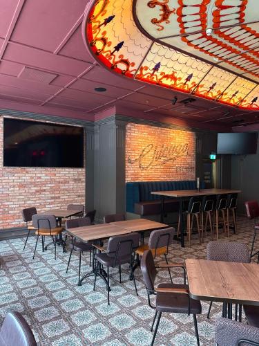 a dining room with tables and chairs and a ceiling at Radisson Blu Plaza Hotel, Oslo in Oslo