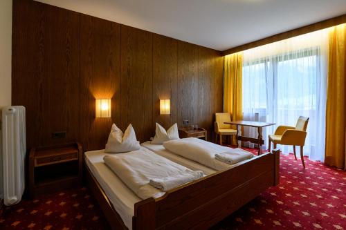 a bedroom with a large bed in a room at Zillertalerhof in Ried im Zillertal