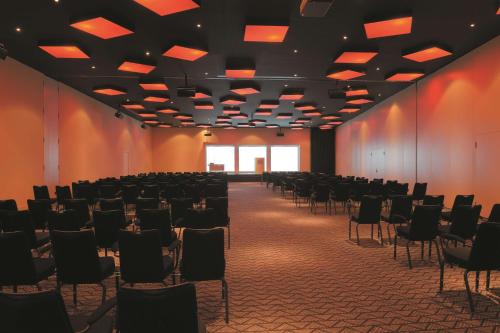 a large room with chairs and a large window at Radisson Blu Hotel Zurich Airport in Kloten
