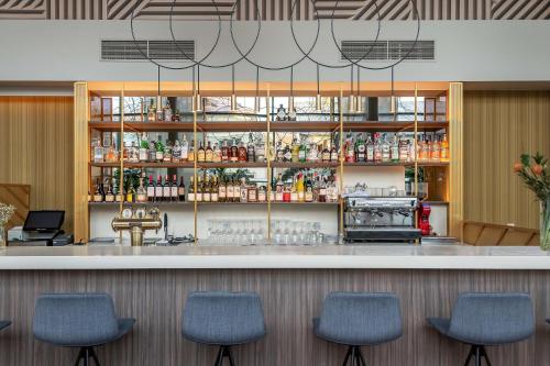 a bar in a restaurant with blue chairs at Radisson Hotel Kaunas in Kaunas