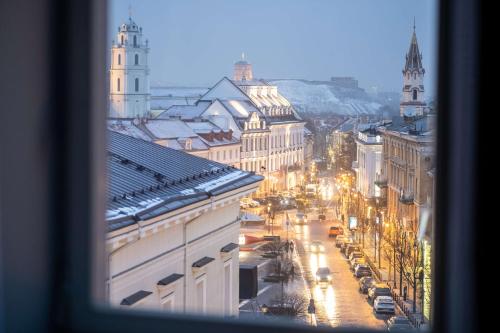 a view from a window of a city street at night at Radisson Collection Astorija Hotel, Vilnius in Vilnius