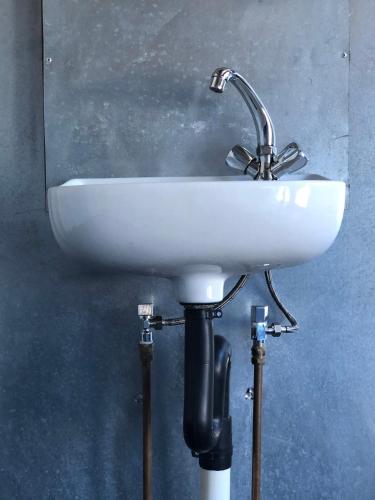 a white sink on a stand in a bathroom at Moae Campsite 