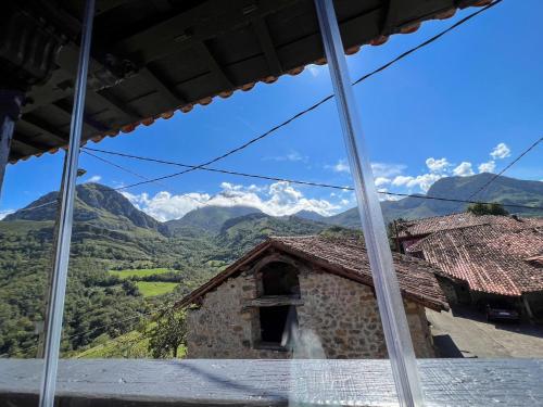 a view from the window of a building with mountains in the background at El Refugio del Busgosu in Pen