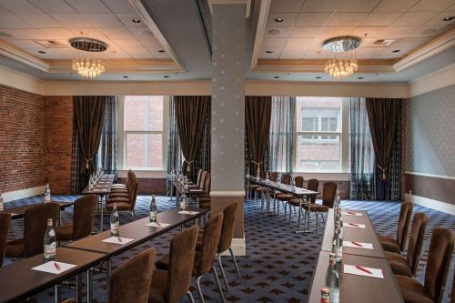 a dining room with long tables and chairs at The Alexis Royal Sonesta Hotel Seattle in Seattle