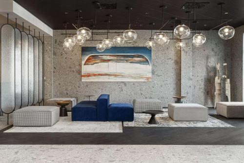 a lobby with blue chairs and tables and lights at Radisson Blu Resort & Conference Center, Ostróda Mazury in Ostróda