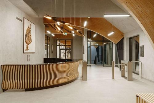a lobby with a bench and a table in a building at Radisson Blu Resort & Conference Center, Ostróda Mazury in Ostróda