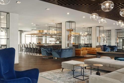 a lobby with couches and chairs and a bar at Radisson Blu Resort & Conference Center, Ostróda Mazury in Ostróda