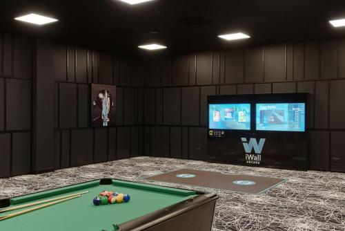 a room with a pool table and a tv at Radisson Blu Resort & Conference Center, Ostróda Mazury in Ostróda