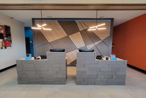 a lobby with two reception desks in a building at Best Western Plus Executive Residency Carlsbad Hotel in Carlsbad