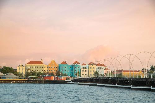 a bridge over a body of water with buildings at Brion City Hotel BW Signature Collection in Willemstad