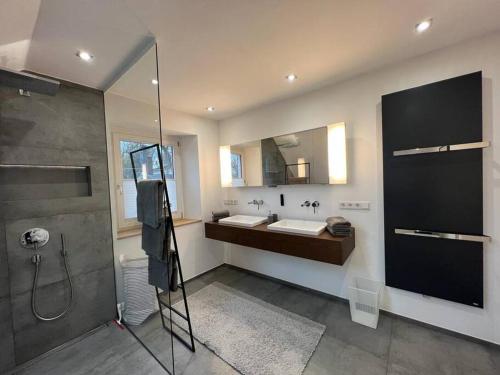 a large bathroom with two sinks and a shower at Historische Villa mit Garten, Luxus in Meerbusch