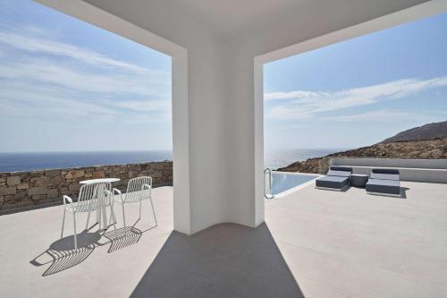 a white house with a view of the ocean at Radisson Blu Euphoria Resort, Mykonos in Kalo Livadi