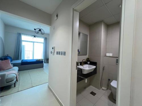 a bathroom with a sink and a toilet in a room at Warm and Elegant Studio in Dubai in Dubai